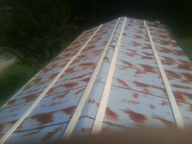 Rusted metal roof panels with new wood purlins before replacement — Storm Damage Roof Repair in Redding by Roofing Brothers